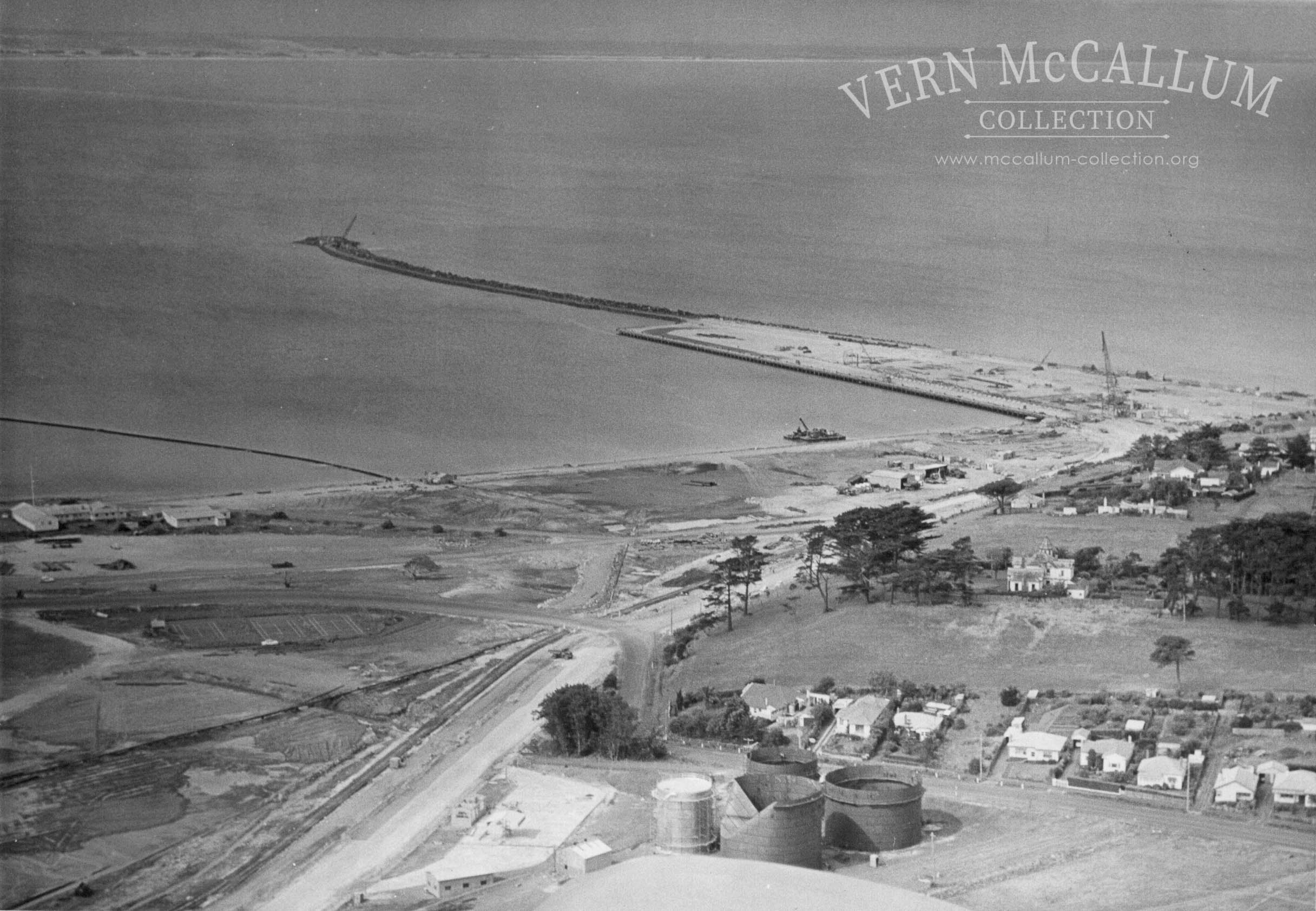Aerial shot of Portland harbour and the Shell black oil tanks in the foreground.