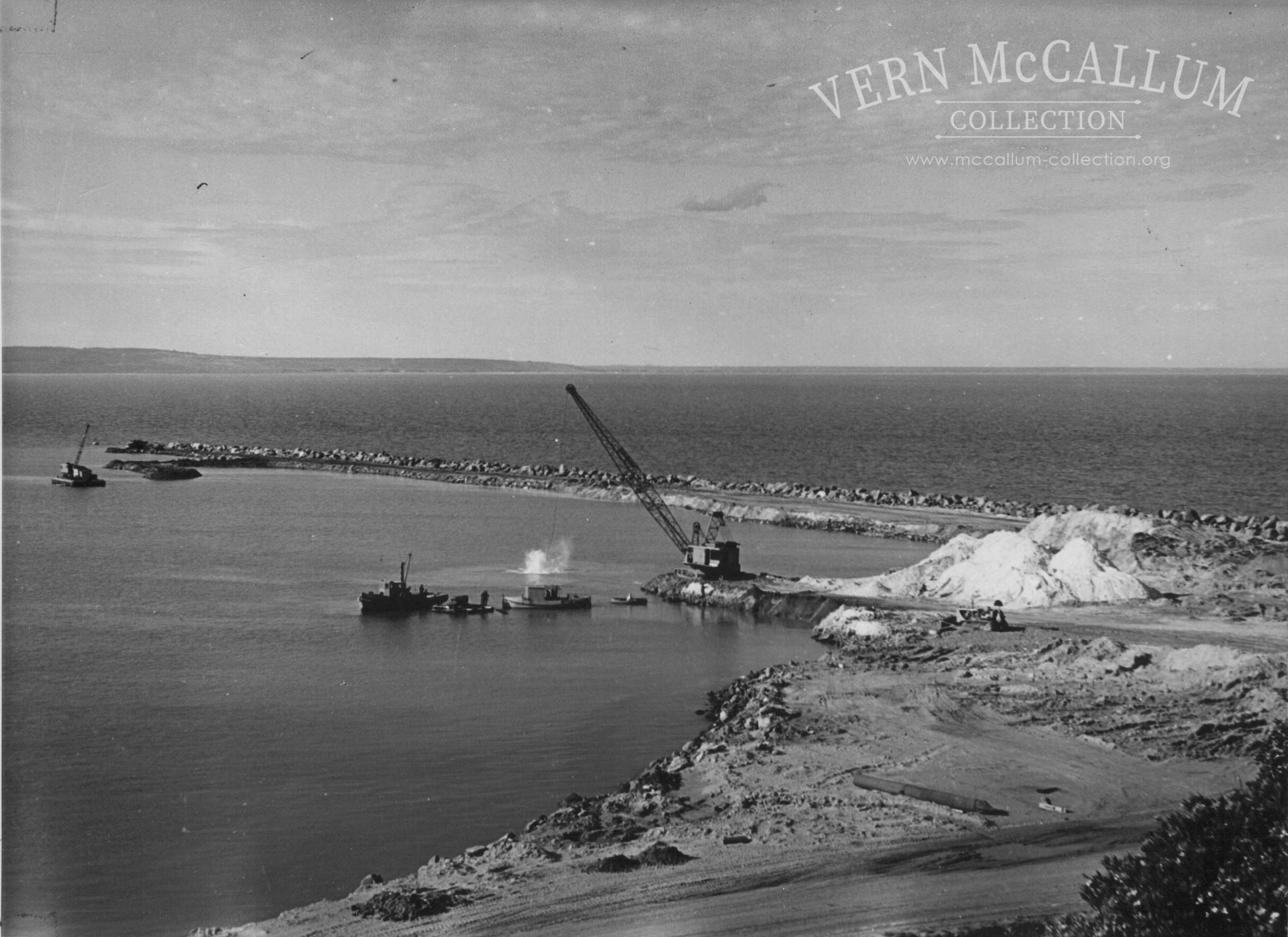 The start of the K. S. Anderson Wharf, Portland. The dredge bucket has just hit the water, the work boat Sterling divers boat and the Marion drag line can also be seen .