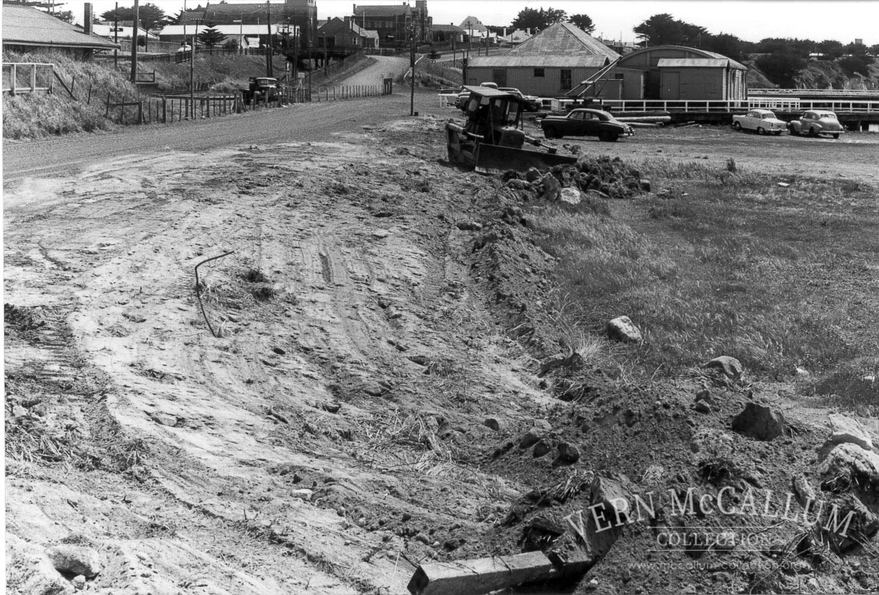 Down ramp to the beach area, Portland. The building behind the dozer was the carpenters workshop and engineers and blacksmith's shop.