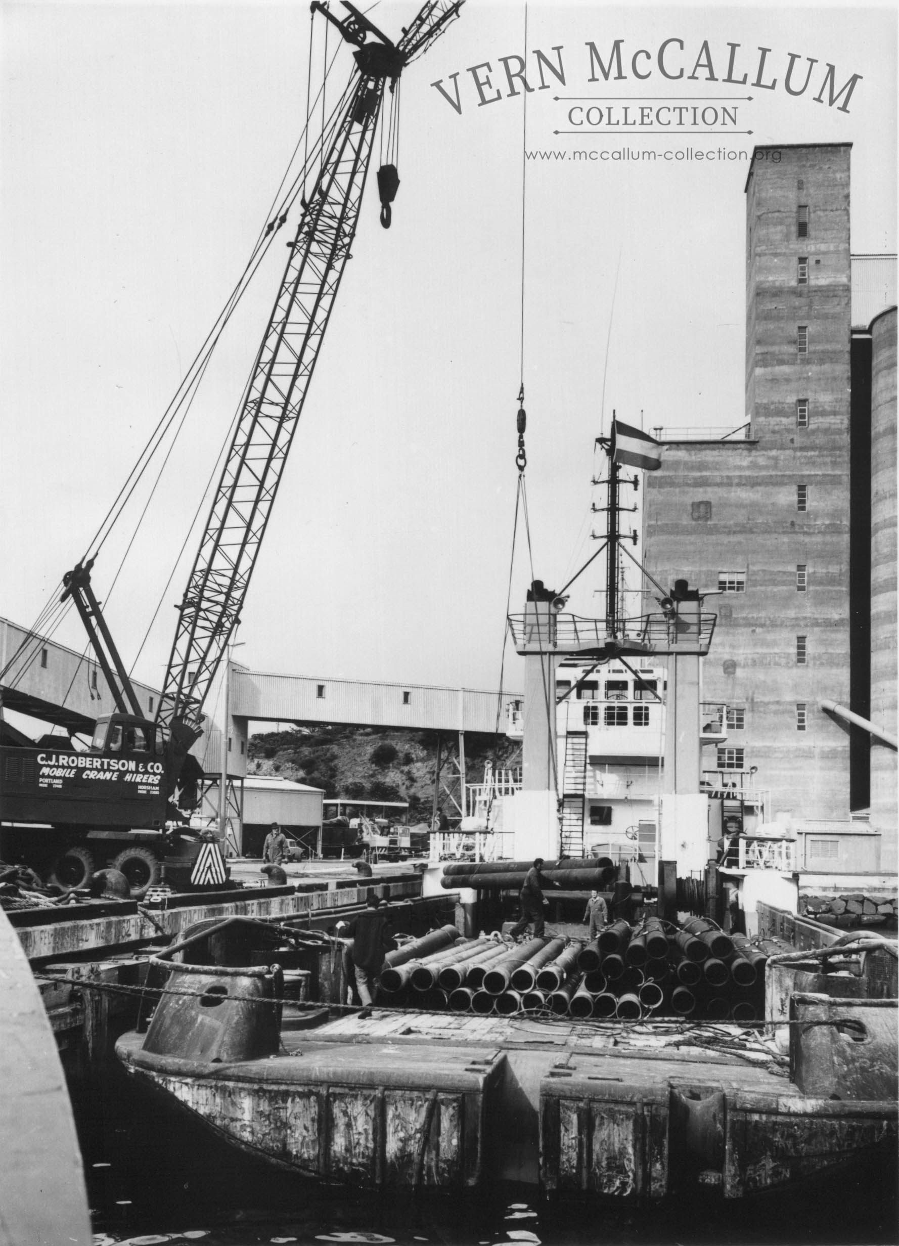 Loading the oil rig tender boats.using C J Robertson cranes .