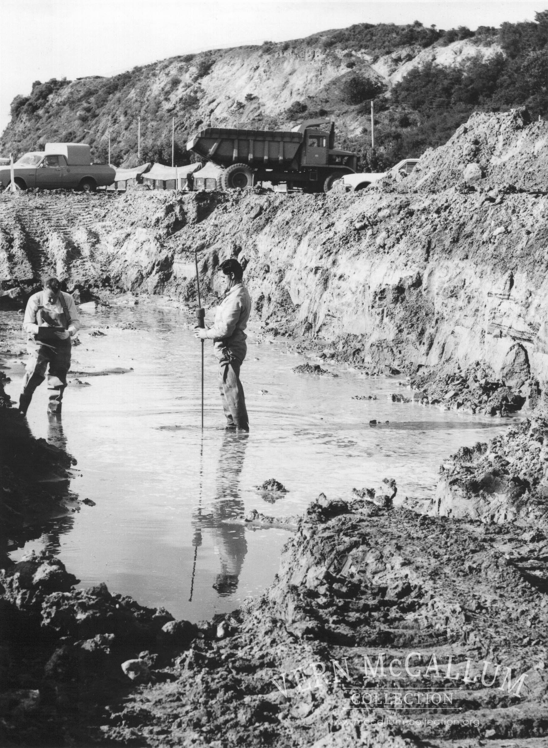 Surveying foundations of wheat shed.Noel Peck on right.