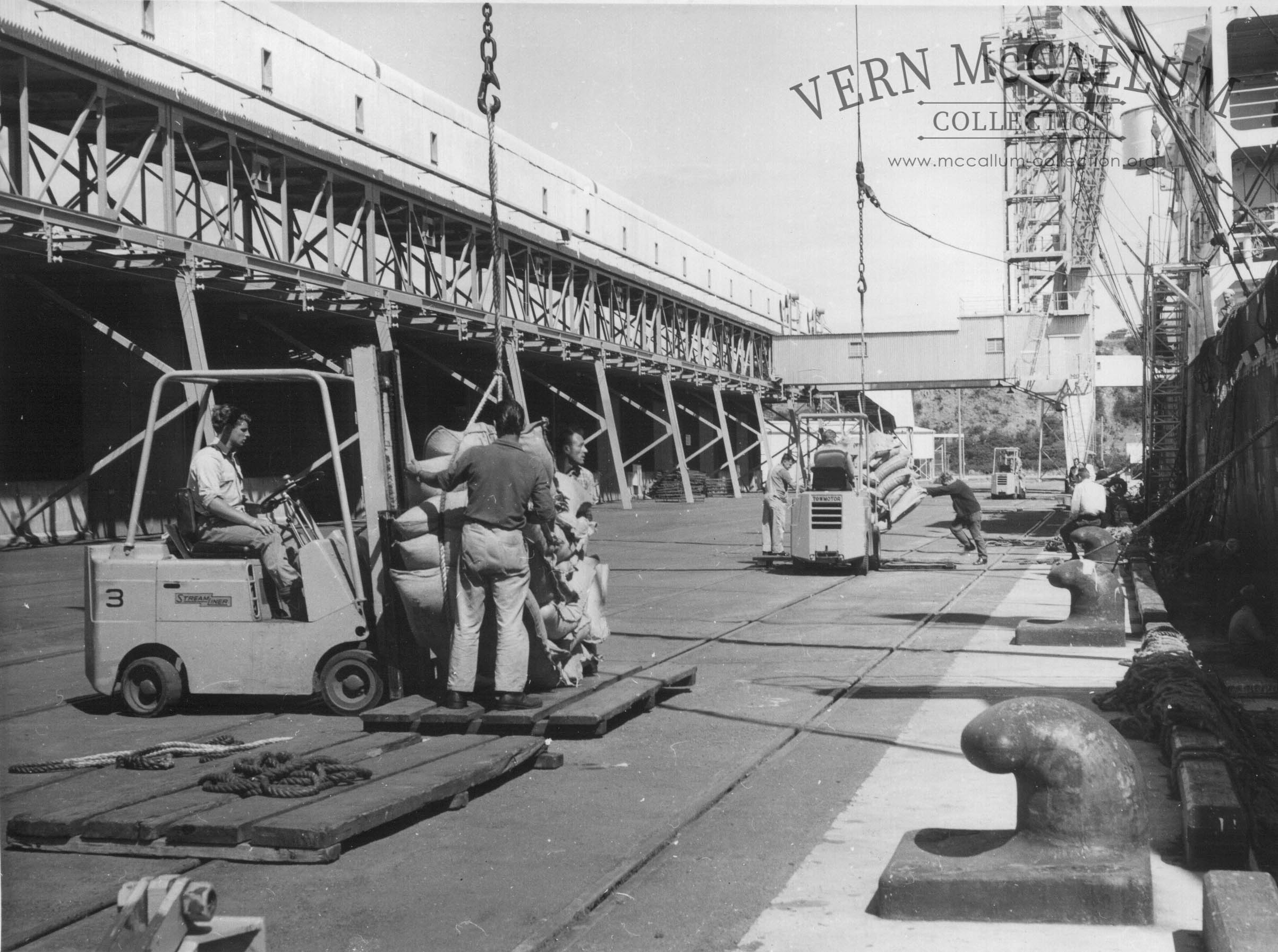 Loading bags of wheat.K.S. Anderson Wharf.
