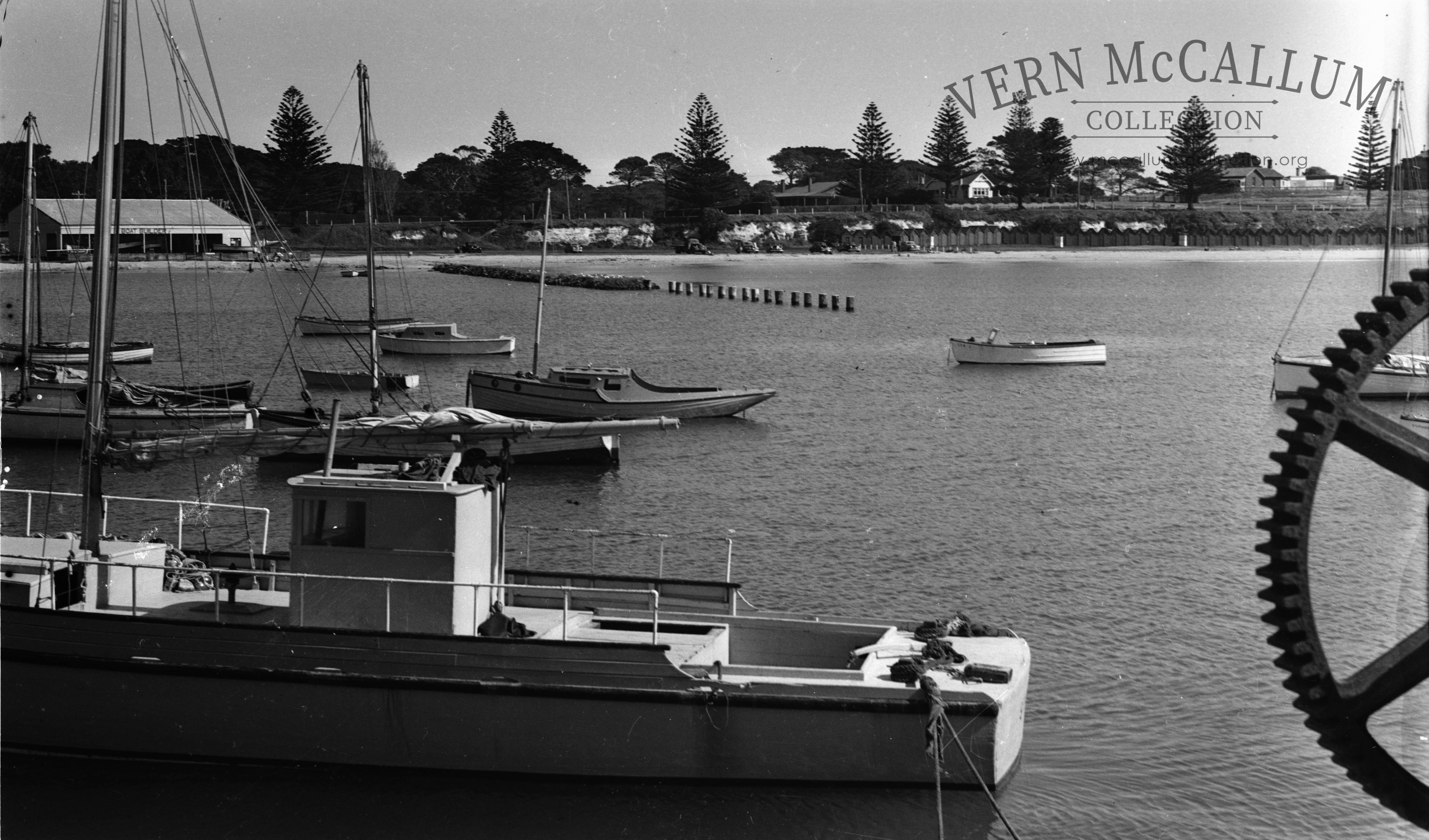 Fishing boats in the harbour note the old bathing boxes.