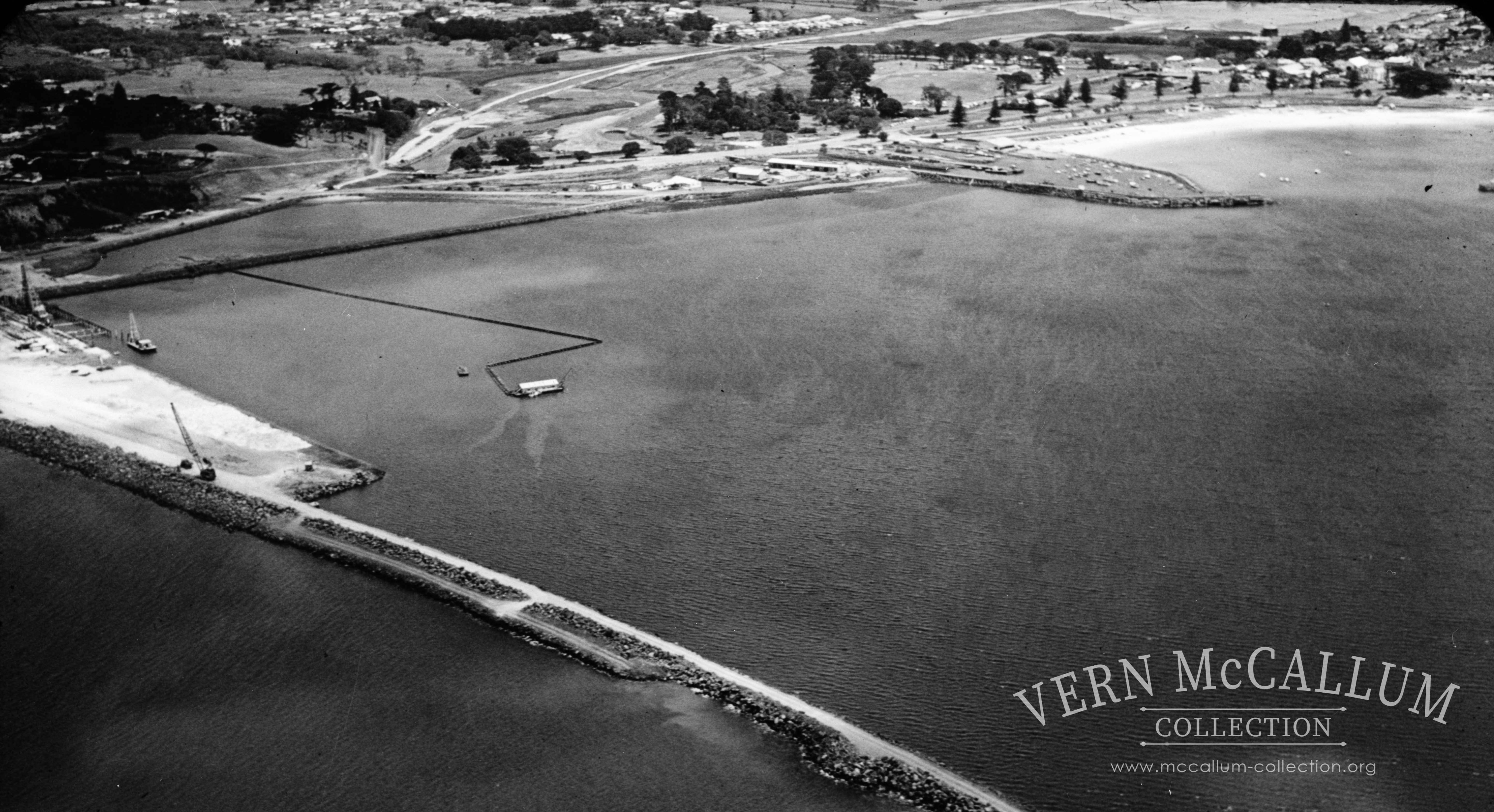 View of the port during construction. Sand was pumped into the area that had been closed off with a rock wall to reclaim a large area for the port buildings etc.