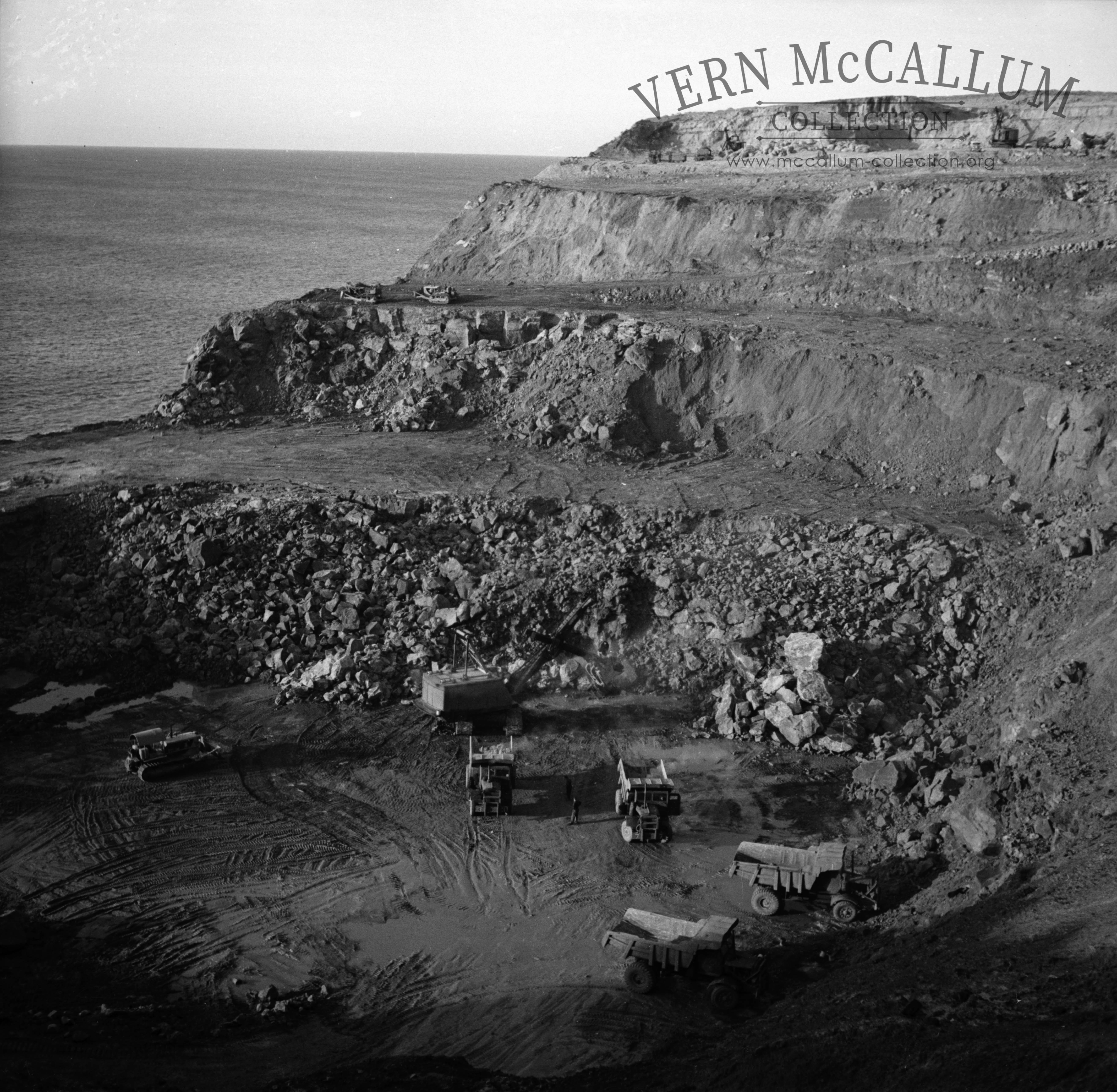 Excavating rock at Cape Grant to be carted to the port with the Euclid trucks.
