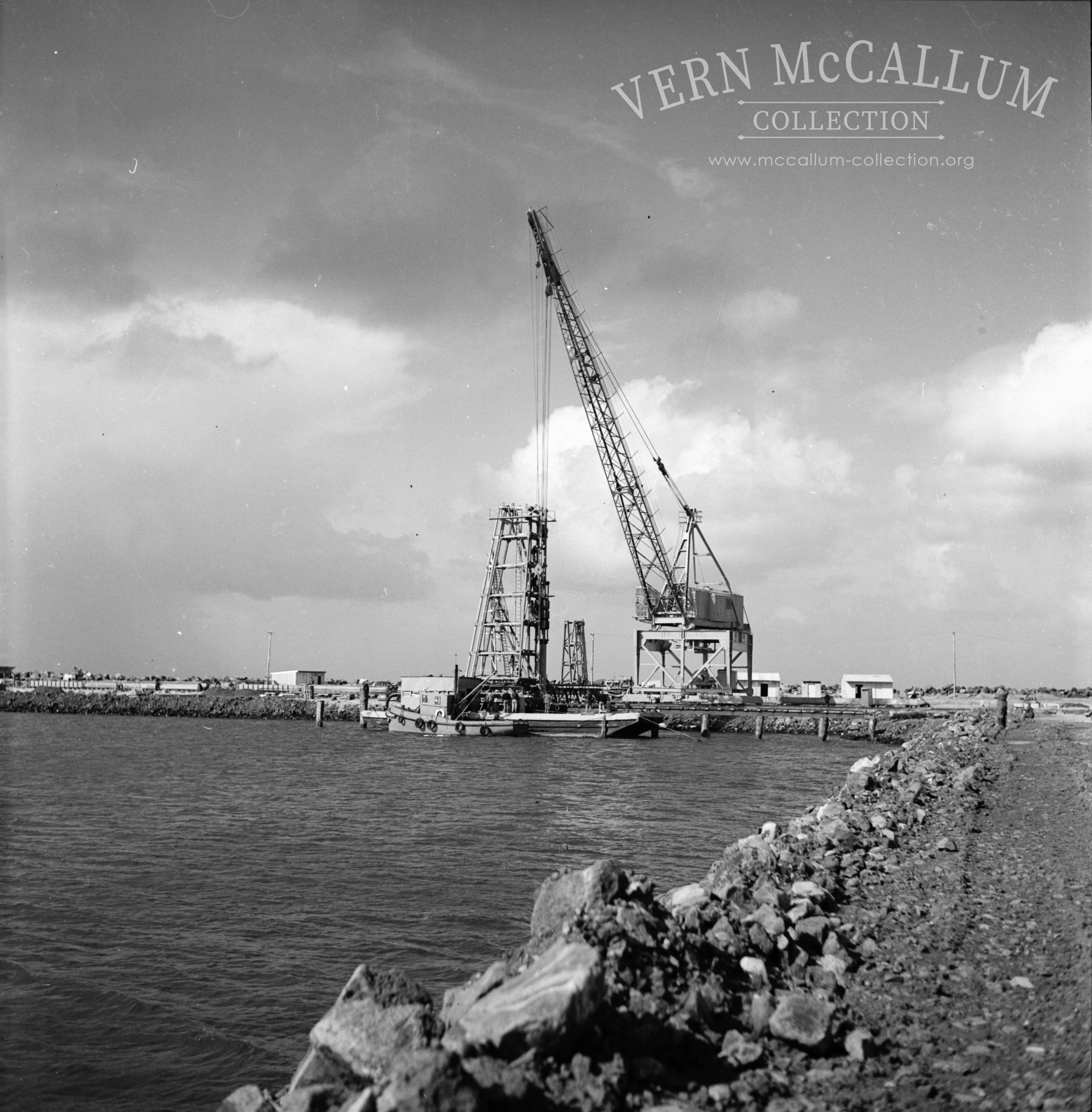 Hornibrooks crane and lighter barge in the harbour.