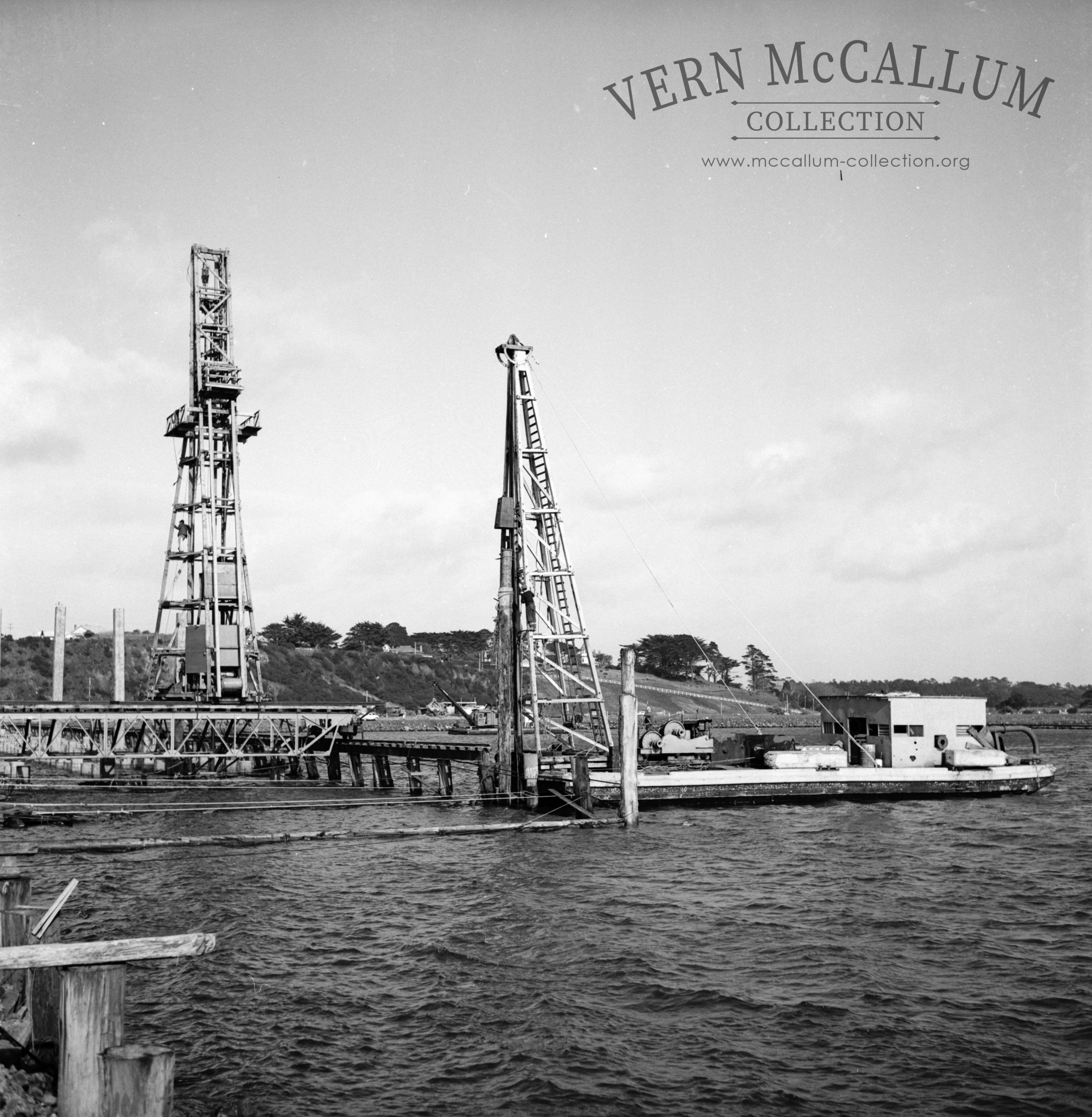 The Port pile driver driving piles for Hornibrooks pile driver.The rails for hornibrooks crane was placed on these timber piles that were cut off after the wharf had been constructed.