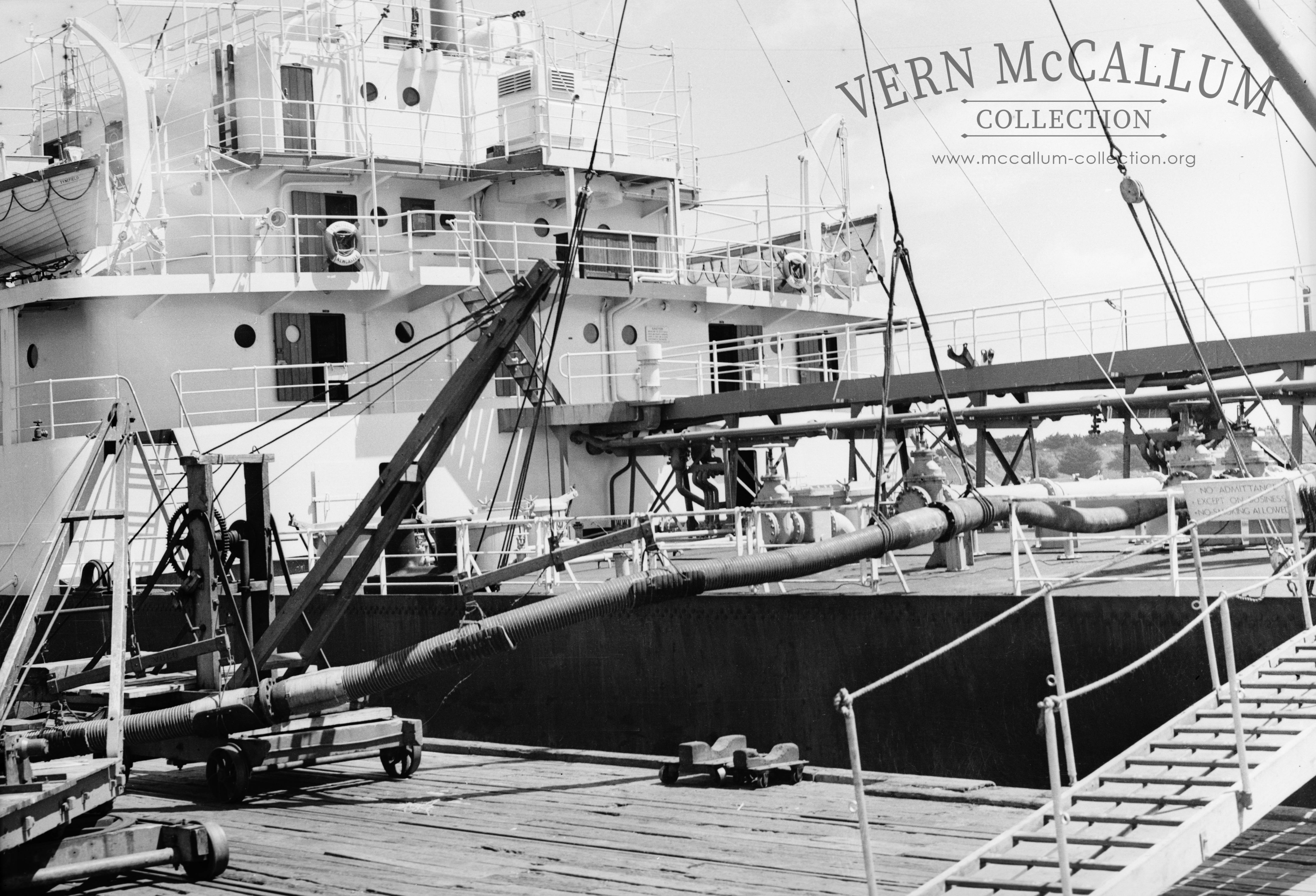 A ship tied up on the ocean pier. Unloading fuel.