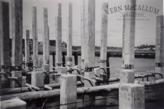 Pilons spliced ready to be driven deeper into the sea bed when building the port.  photo from "The Peter Burch Collection".