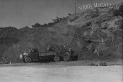 Loading of truck. Portland port area. George Wallace on the loader, a Fordson Detroit pre 1928 Moore cable loader.