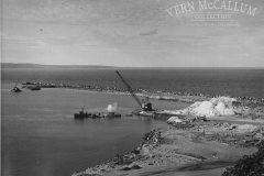 The start of the K. S. Anderson Wharf, Portland. The dredge bucket has just hit the water, the work boat Sterling divers boat and the Marion drag line can also be seen .