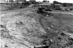 Down ramp to the beach area, Portland. The building behind the dozer was the carpenters workshop and engineers and blacksmith's shop.