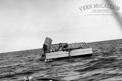Unloading the barge at sea. When the barge had been loaded by the dredge it was taken out to sea and dumped in the deep water. The fill had been dredged from the K.S. Anderson wharf area.