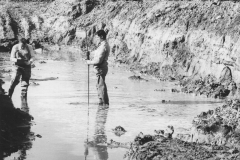 Surveying foundations of wheat shed.Noel Peck on right.