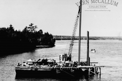 Driving piles at an unknown location this glass neg was from the port of portland collection