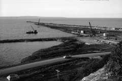 The port area during construction note an area was surrounded by a rock wall then fill was dredged or pumped in to fill the area.