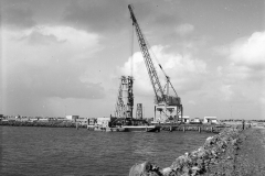 Hornibrooks crane and lighter barge in the harbour.