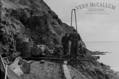 Workers drilling ready for another blast half way up the rock face as seen in photo no 6485.