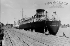 A ship tied up on the ocean pier. Unloading fuel.